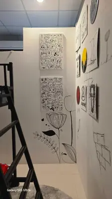 a room with a wall with drawings on it at 89 Bed & Studio Hostel in Godown
