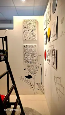a wall with drawings and pictures on it at 89 Bed & Studio Hostel in Godown