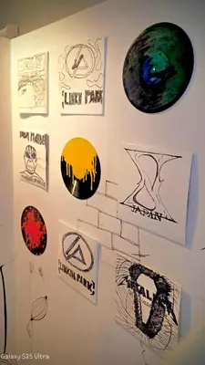 a wall with many stickers on a wall at 89 Bed & Studio Hostel in Godown