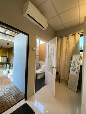 a bathroom with a toilet and a white door at 89 Bed & Studio Hostel in Godown