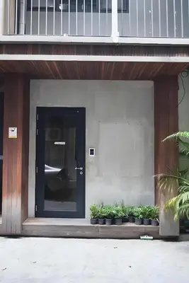 a door to a building with a bunch of plants at XX GO INN Silom - BTS Saint Louis สีลม in Bangkok