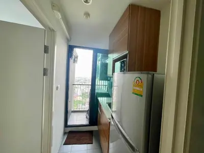 a kitchen with a refrigerator and a balcony at the Tree Rio Bang-Aor in Bang O