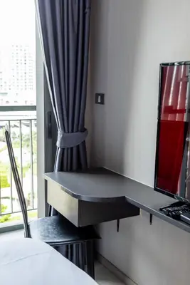 a desk in a hotel room with a window at Luxurious Apartment with Train Access in Bangkok