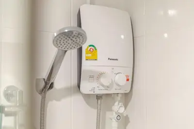 a shower head and a hair dryer in a bathroom at Perfect 1BR at MRT Bangson By Orn in Bang Su