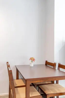 a wooden table and chairs with a vase on it at Perfect 1BR at MRT Bangson By Orn in Bang Su