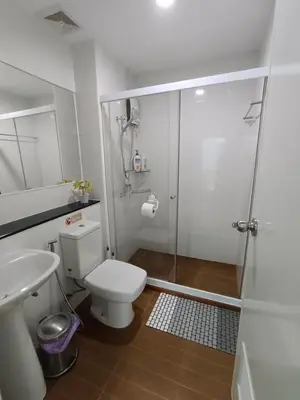a bathroom with a shower and a toilet and a sink at Perfect 1BR at MRT Bangson By Orn in Bang Su