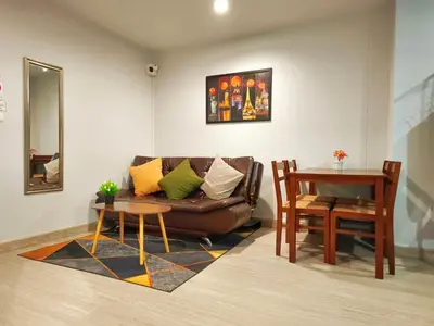 a living room with a couch and a table at Perfect 1BR at MRT Bangson By Orn in Bang Su