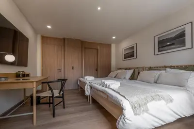 a bedroom with two beds and a table and a desk at Whole Floor Penthouse, 3 Bedroom 3 Bath, Next to Metro Station in Bangkok
