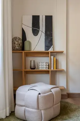 a white ottoman in a room with a book shelf at Whole Floor Penthouse, 3 Bedroom 3 Bath, Next to Metro Station in Bangkok