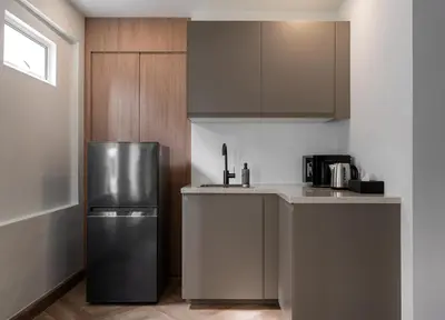 a kitchen with a stainless steel refrigerator and cabinets at Whole Floor Penthouse, 3 Bedroom 3 Bath, Next to Metro Station in Bangkok
