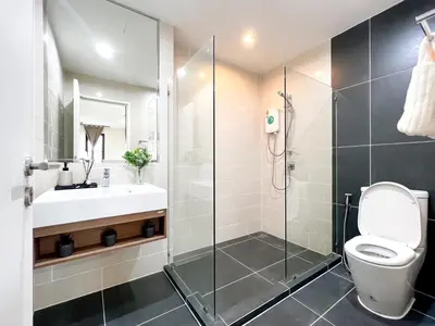 a bathroom with a shower and a toilet and a sink at The Gallery Bearing in Samut Prakan
