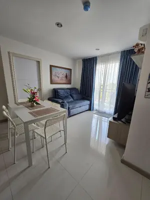 a living room with a table and a couch at Thaiphil Condo in Nonthaburi