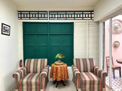 two chairs and a table in front of a garage at Atlas Hostel Khaosan in Bangkok