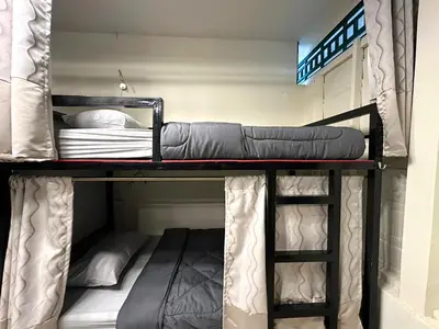 a couple of bunk beds in a room at Atlas Hostel Khaosan in Bangkok