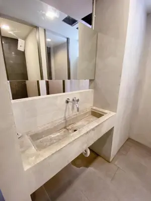 a bathroom with a sink and a mirror at GO INN Silom BTS Surasak สถานีสุรศักดิ์ in Bangkok