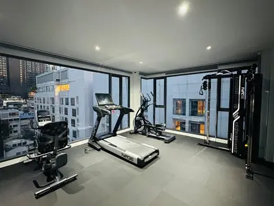 an apartment gym with a view of a city at 6th Avenue Sukhumvit BKK 302 BTS Asoke & Nana MRT Sukhumvit in Bangkok