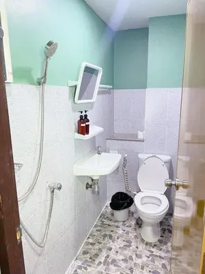 a bathroom with a shower and a toilet and a sink at GO INN The Giant Swing เสาชิงช้า in Bangkok