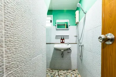 a bathroom with a sink and a shower at GO INN The Giant Swing เสาชิงช้า in Bangkok