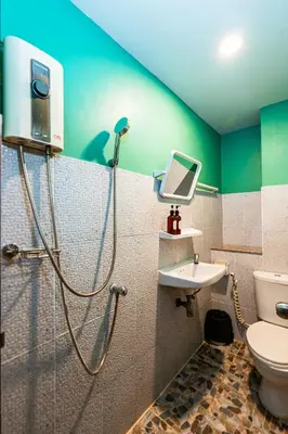 a bathroom with a shower and a toilet and a sink at GO INN The Giant Swing เสาชิงช้า in Bangkok