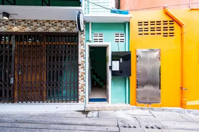 an entrance to a building with a green door at GO INN The Giant Swing เสาชิงช้า in Bangkok