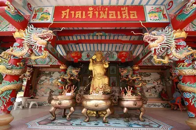 a temple with a statue of a lion in a room at GO INN The Giant Swing เสาชิงช้า in Bangkok