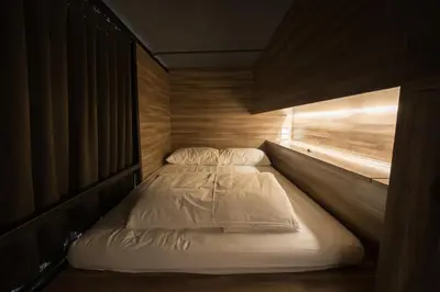 a couple of beds in a small room at Fellows House in Bangkok