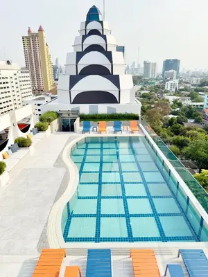 a swimming pool on the roof of a building at The Quarter Saphankhwai by UHG in Bangkok