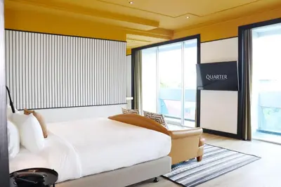 a hotel room with a bed and a large window at The Quarter Saphankhwai by UHG in Bangkok