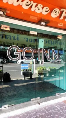 a store front with a sign in the window at XX GO INN Khaosan ข้าวสาร กรุงเทพมหานคร in Bangkok