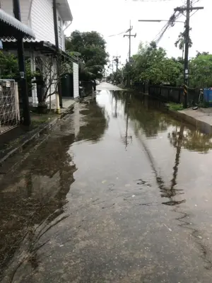 a street filled with water next to a house at ประเทศไทย in Ban Bang Krang