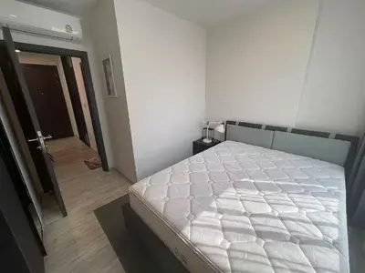 a bedroom with a large white bed and a hallway at \u5c0f\u592a\u9633\u6c11\u5bbf in Bangkok