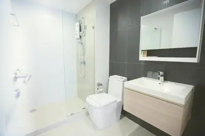 a bathroom with a toilet and a shower and a sink at Park 19 Hotel in Bangkok