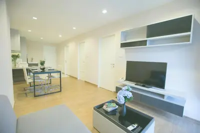 a living room with a large flat screen tv at Park 19 Hotel in Bangkok