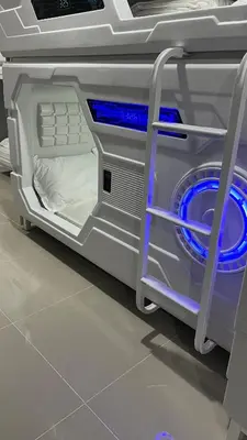 a washing machine with blue lights inside of it at Kiwi Capsule Hotel in Bangkok