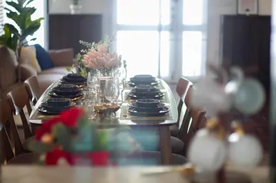 a long table with plates and vases on it at Spacious 4-Bedroom Oasis in the Heart of Sukhumvit in Bangkok