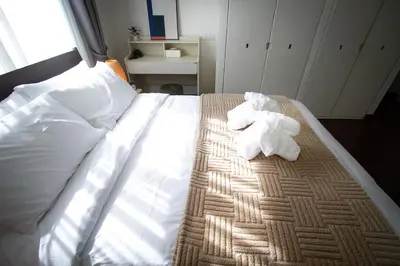 a bed with two towels on top of it at Spacious 4-Bedroom Oasis in the Heart of Sukhumvit in Bangkok