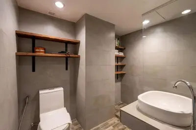a bathroom with a white toilet and a sink at PEONY Rustic Apartment Sukhumvit, Nana BTS in Bangkok