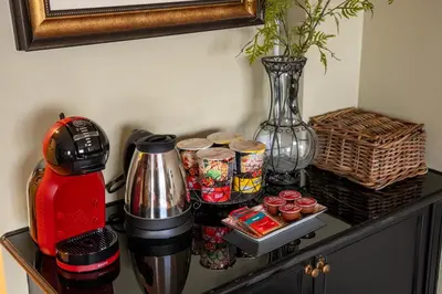 a table with a coffee maker and a vase on it at PEONY Rustic Apartment Sukhumvit, Nana BTS in Bangkok