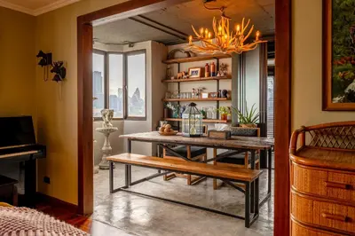 a dining room with a table and a bench at PEONY Rustic Apartment Sukhumvit, Nana BTS in Bangkok