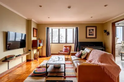 a living room with a couch and a flat screen tv at PEONY Rustic Apartment Sukhumvit, Nana BTS in Bangkok