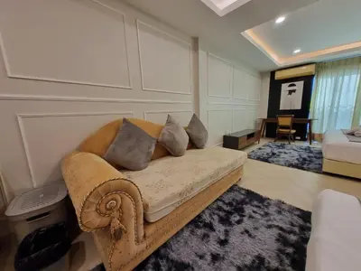 a living room with a couch with pillows on it at RB9 Oliver's House in Kaset in Ban Yang