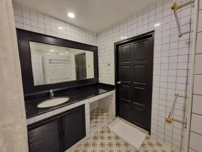 a bathroom with a sink and a black door at RB9 Oliver's House in Kaset in Ban Yang