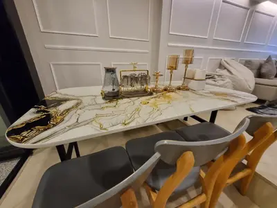 a dining room with a marble table and chairs at RB9 Oliver's House in Kaset in Ban Yang