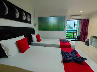a bedroom with two beds with red and black bows at Pak-D Resort in Bangkok