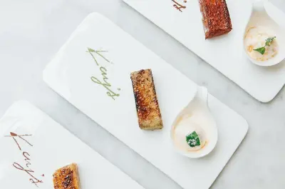 a set of three white plates with food on them at K Maison Boutique Hotel in Bangkok