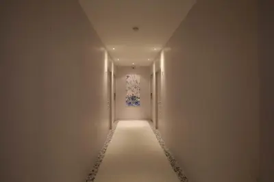 an empty hallway with a painting on the wall at K Maison Boutique Hotel in Bangkok