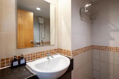 a bathroom with a sink and a mirror at Nature Boutique Hotel Ratchayothin in Bangkok