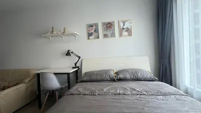 a bedroom with a bed and a table and a desk at GM bangson home in Bangkok