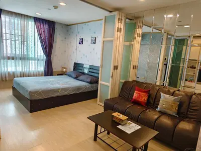 a living room with a bed and a couch at The Central Bangkok Station1 in Bangkok