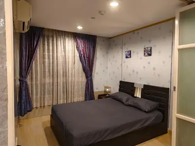 a bedroom with a bed and a window at The Central Bangkok Station1 in Bangkok